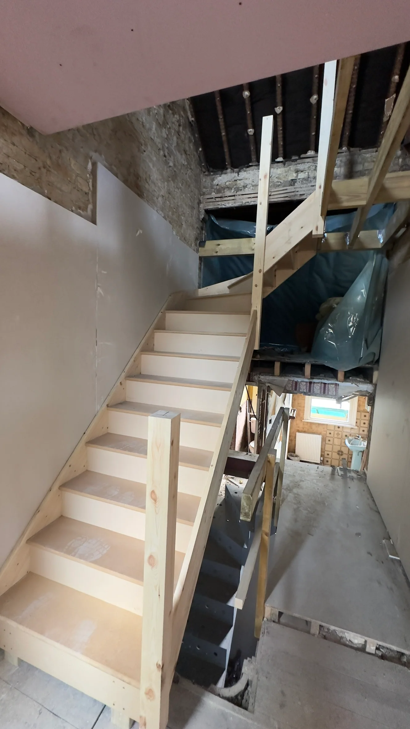Unfinished made-to-measure timber staircase on a live building project