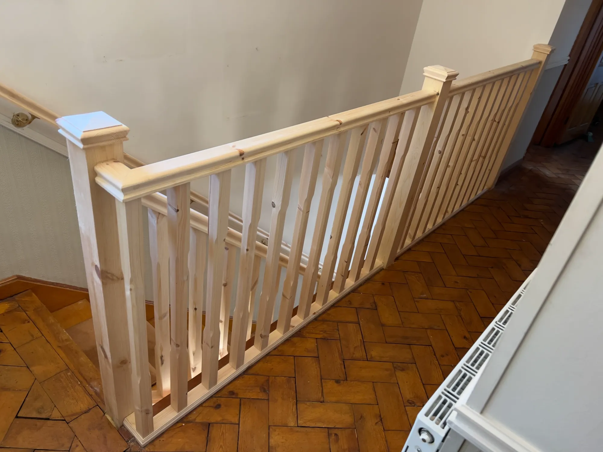 Newly installed staircase balustrade with 90mm square newel posts and straight spindles for added strength and stability.