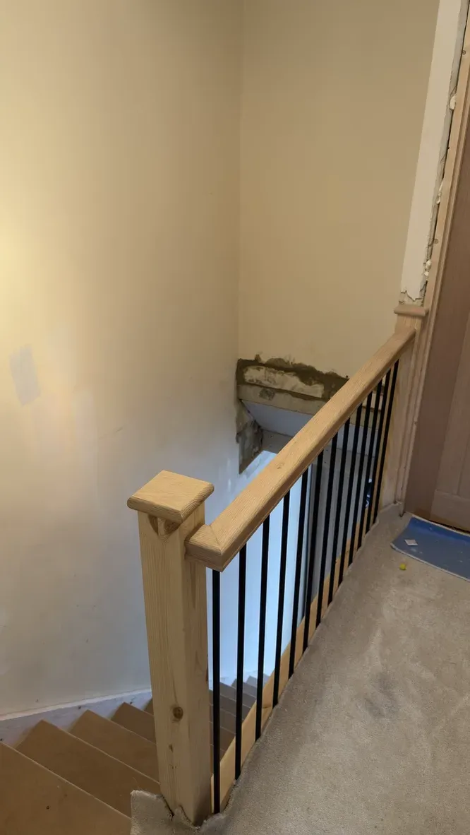 Oak handrail and matt black metal spindles on new staircase landing in Rainham, Kent