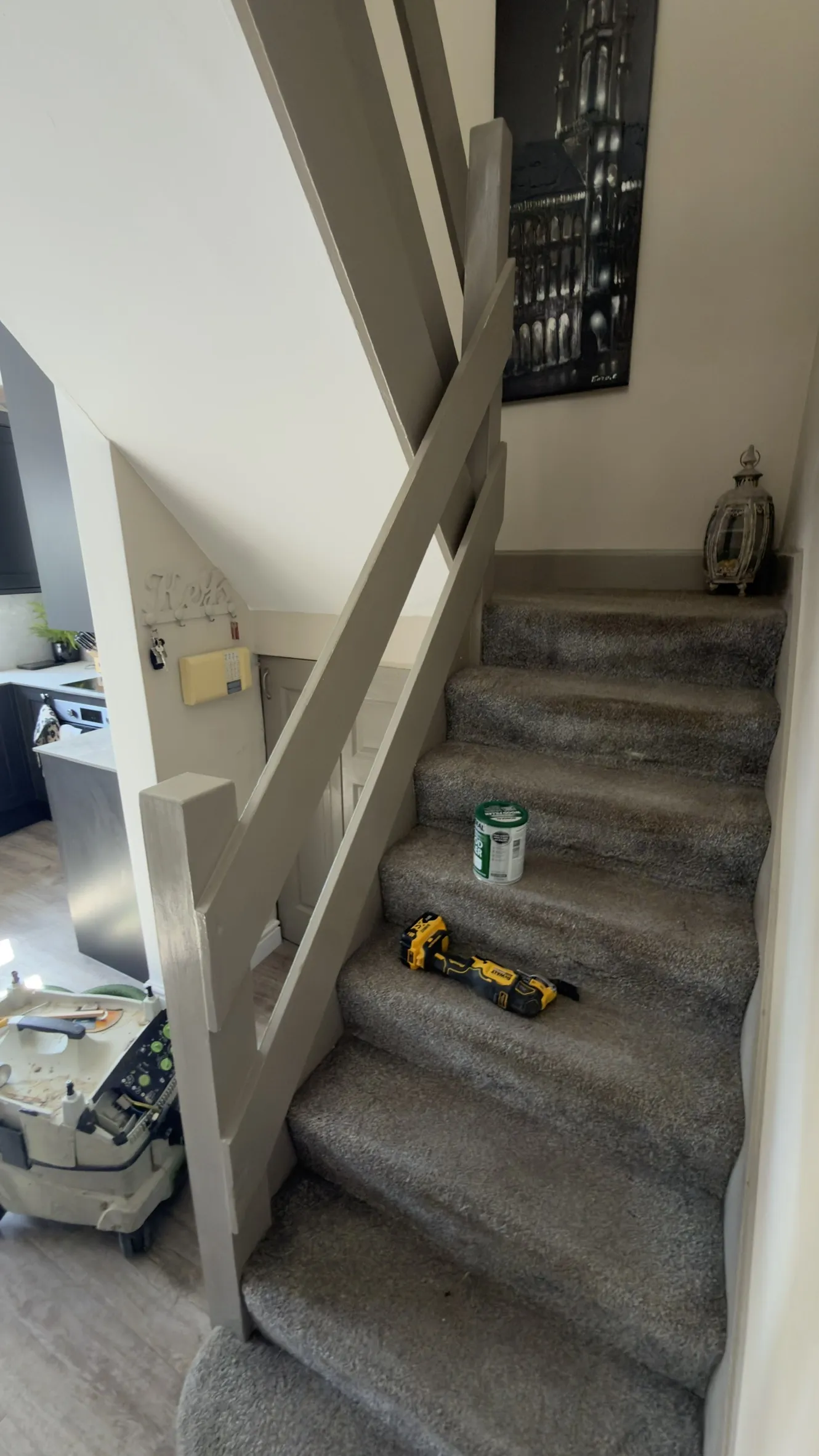The Gravesend staircase before work, with painted newel posts and ranch-style rails.