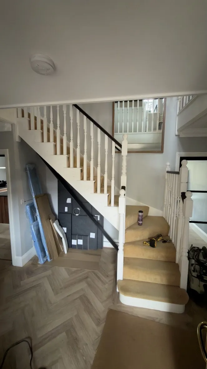 Staircase before renovation with white turned newel posts and spindles in Hildenborough.
