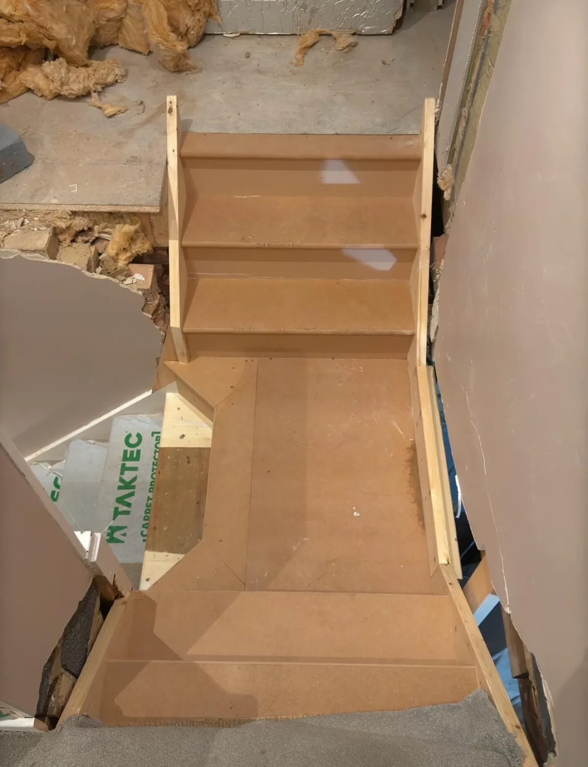 Constructed staircase with a new landing structure in progress, connecting an older home to a modern extension in Sidcup