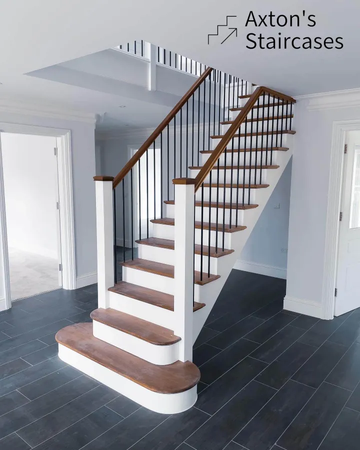 Modern staircase with American Black Walnut treads and 16mm black spindles, installed in a new build home in Bromley.